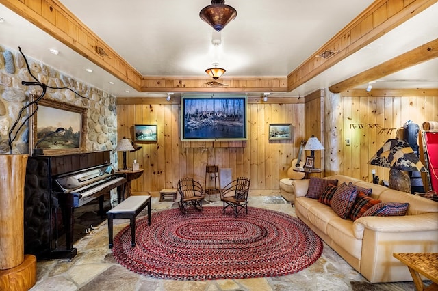 sitting room with wooden walls, a raised ceiling, and light tile floors