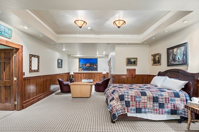 carpeted bedroom with a tray ceiling