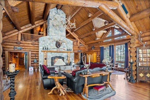 living room featuring hardwood / wood-style floors, wooden ceiling, and log walls