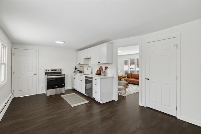 kitchen with white cabinetry, sink, baseboard heating, and appliances with stainless steel finishes