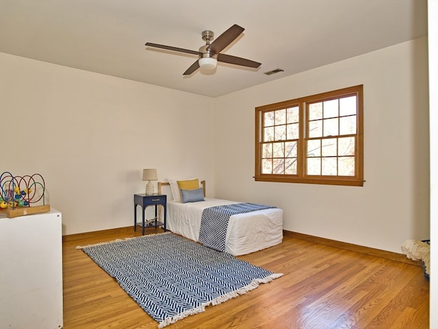 bedroom with ceiling fan and light hardwood / wood-style floors