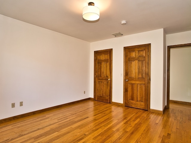 unfurnished bedroom featuring light wood-type flooring