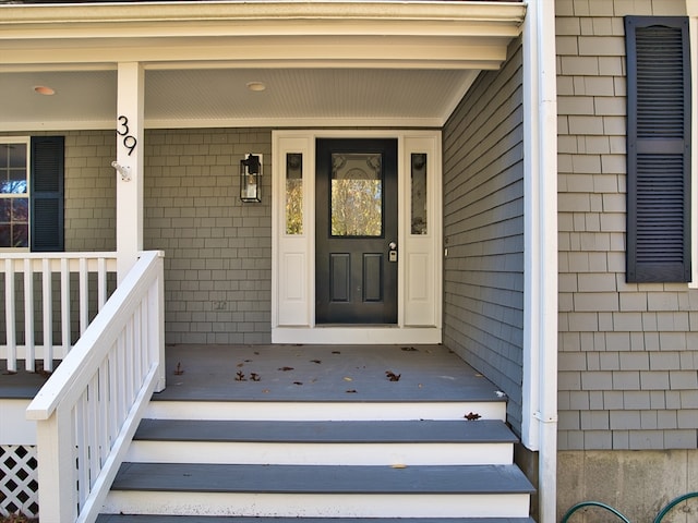 view of exterior entry with covered porch