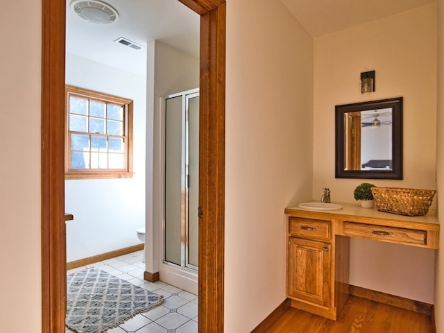 hall with sink and light hardwood / wood-style flooring