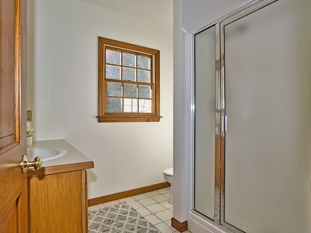 bathroom with tile patterned floors, vanity, toilet, and a shower with door