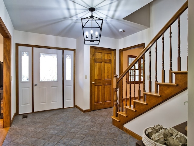 foyer featuring an inviting chandelier