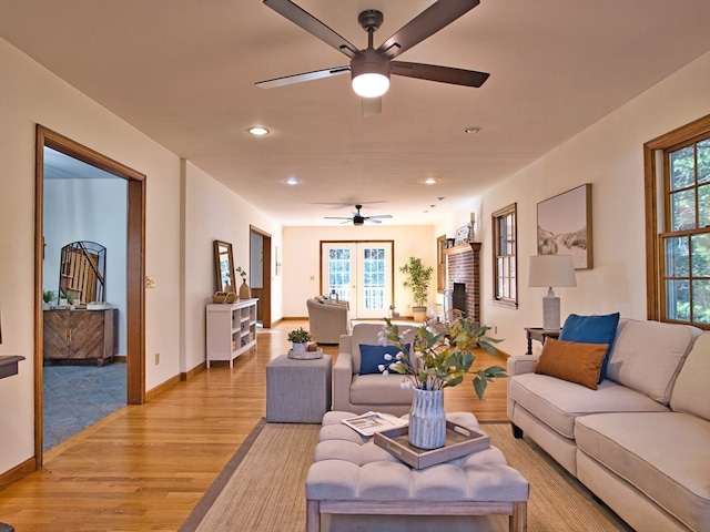 living room featuring ceiling fan and light wood-type flooring