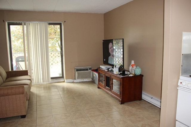 living area with light tile patterned flooring, baseboards, baseboard heating, and a wall unit AC