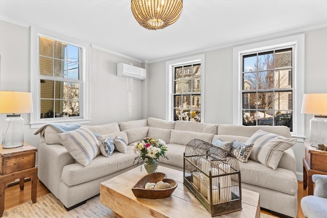 living room featuring ornamental molding, a wall mounted AC, and light wood-style floors