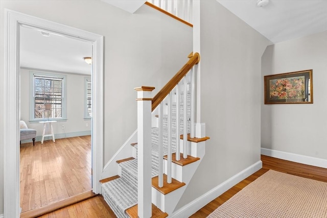 stairs featuring baseboards and wood finished floors