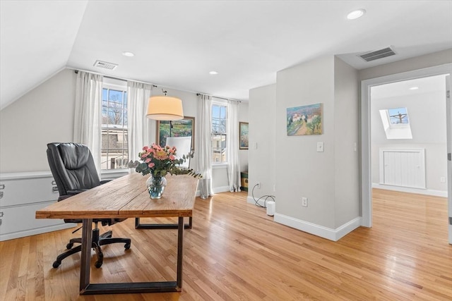 office with light wood-style floors, baseboards, and visible vents