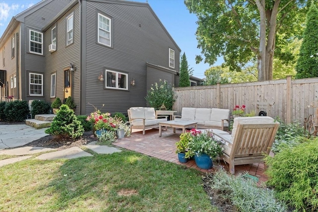 rear view of house with a yard, a patio area, fence, and an outdoor living space