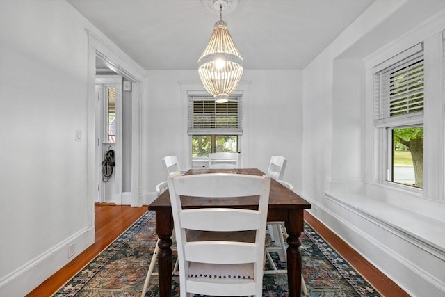 121 W St, Braintree, MA 02184 - dining space with wood finished floors, a chandelier, and baseboards