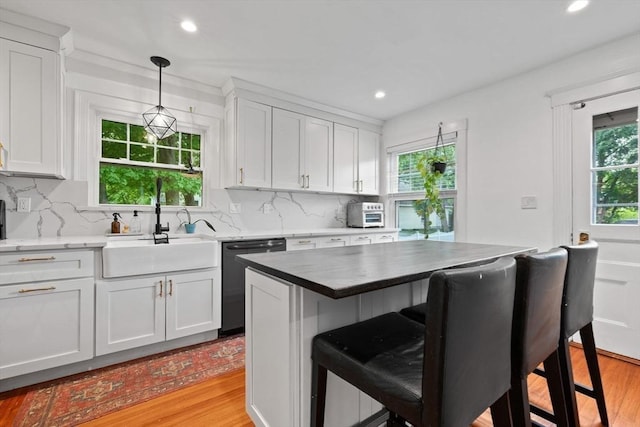 121 W St, Braintree, MA 02184 - kitchen with dishwashing machine, light wood-style floors, a sink, a breakfast bar, and recessed lighting