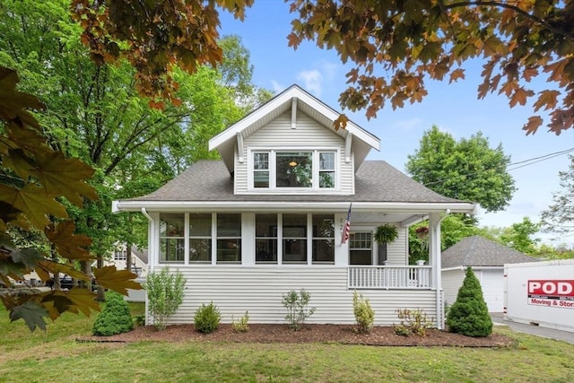 121 W St, Braintree, MA 02184 - view of front facade with covered porch, a front lawn, and a shingled roof