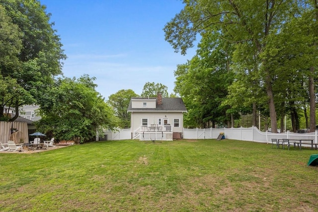 121 W St, Braintree, MA 02184 - back of house with a chimney, a deck, an outdoor fire pit, stairway, and view of scattered trees