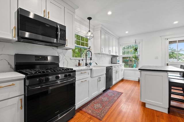 121 W St, Braintree, MA 02184 - kitchen featuring appliances with stainless steel finishes, plenty of natural light, a sink, white cabinetry, and recessed lighting