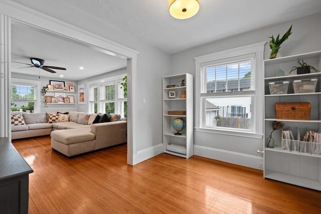 121 W St, Braintree, MA 02184 - living room featuring light wood-type flooring, baseboards, and ceiling fan