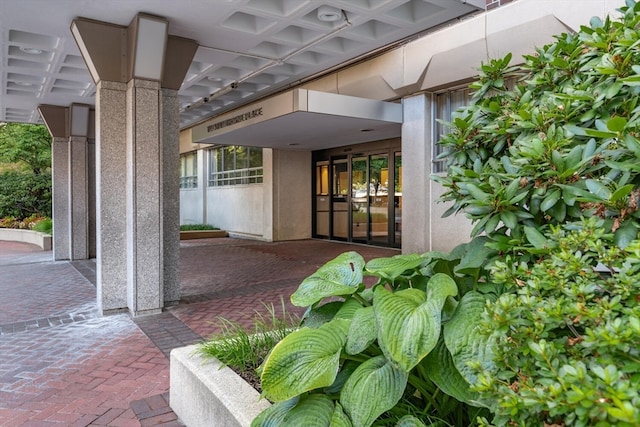 view of exterior entry with a patio area