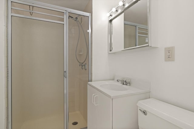 bathroom featuring walk in shower, vanity, and toilet