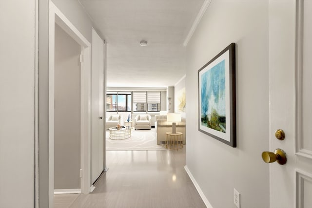 hallway featuring ornamental molding