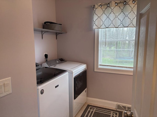 laundry room with laundry area, visible vents, baseboards, separate washer and dryer, and light tile patterned floors