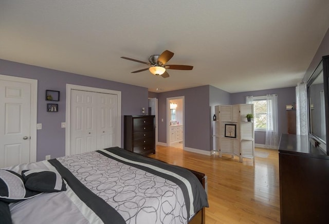 bedroom with ceiling fan, baseboards, a closet, connected bathroom, and light wood-style floors
