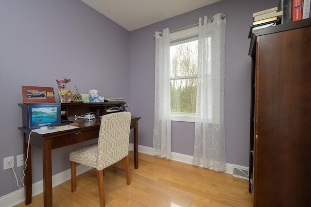 office area with light wood-style floors and baseboards