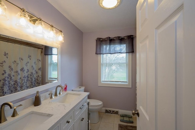 full bath featuring tile patterned flooring, a sink, double vanity, and toilet