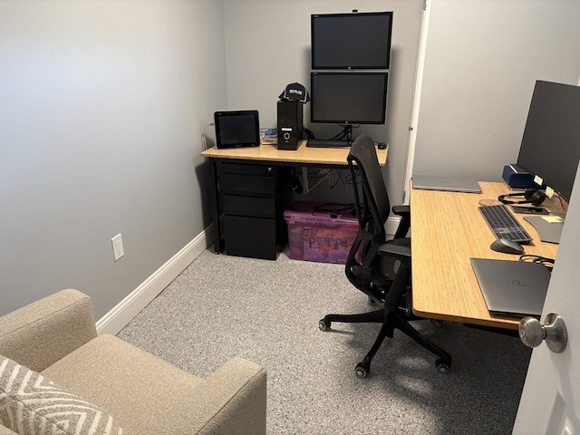 carpeted office space with baseboards