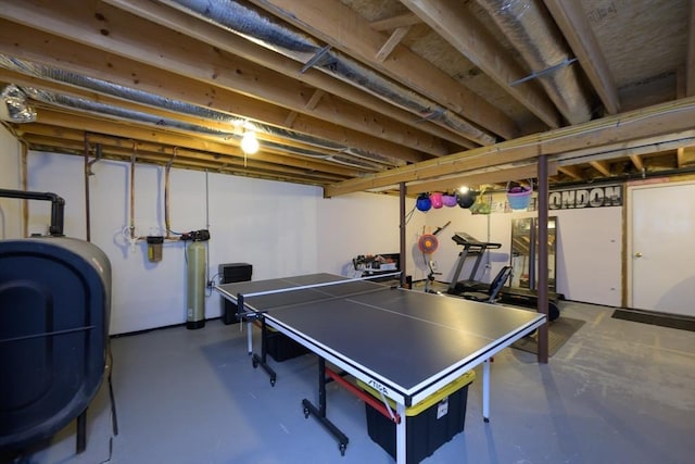 game room featuring concrete floors and heating fuel