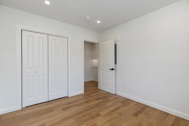 106 Broadway, Salem, MA 01970 - unfurnished bedroom featuring baseboards, light wood finished floors, a closet, and recessed lighting
