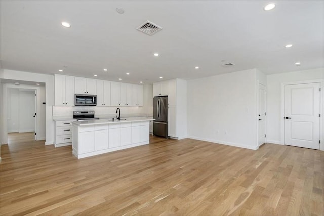 106 Broadway, Salem, MA 01970 - kitchen with appliances with stainless steel finishes, open floor plan, a sink, light countertops, and baseboards
