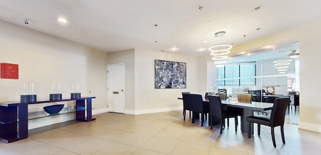 dining area featuring light tile patterned floors and a chandelier