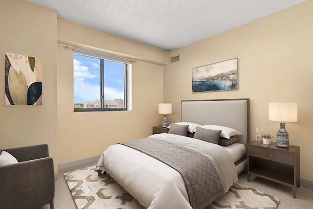 carpeted bedroom featuring a textured ceiling