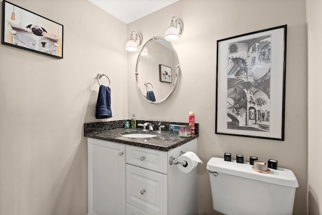 bathroom with toilet and vanity