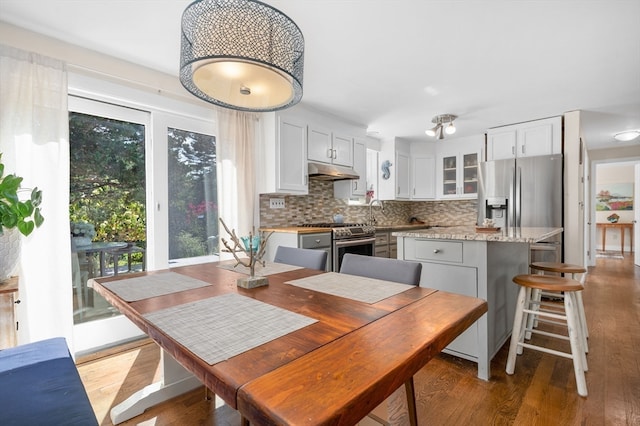 dining space with dark hardwood / wood-style floors