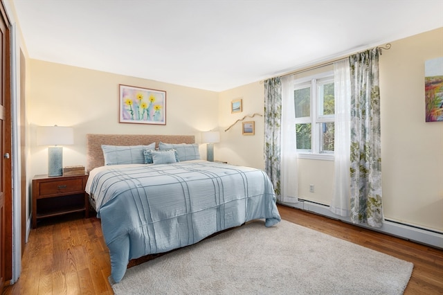 bedroom featuring dark hardwood / wood-style flooring and baseboard heating