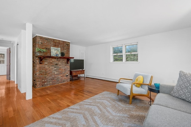 interior space featuring hardwood / wood-style flooring, baseboard heating, and brick wall