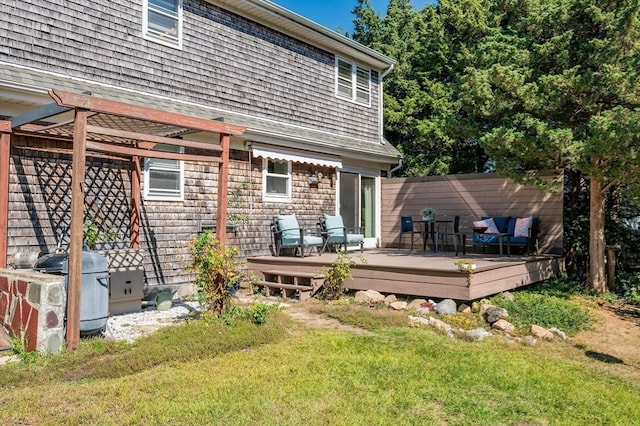 rear view of house featuring a yard and a deck