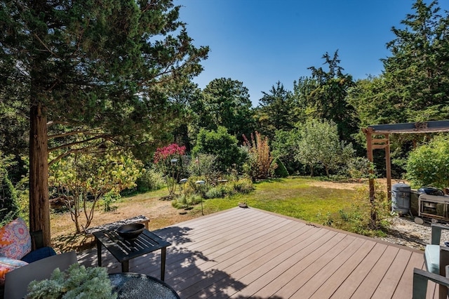 wooden terrace featuring a yard