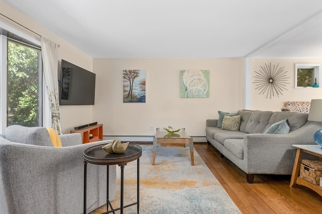 living room with baseboard heating and light wood-type flooring