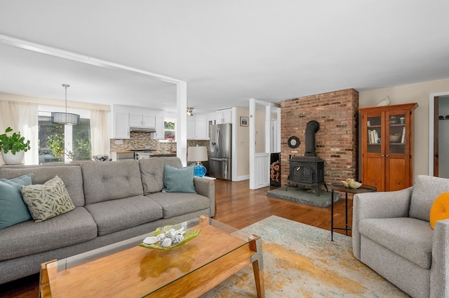 living room featuring a wood stove and hardwood / wood-style floors