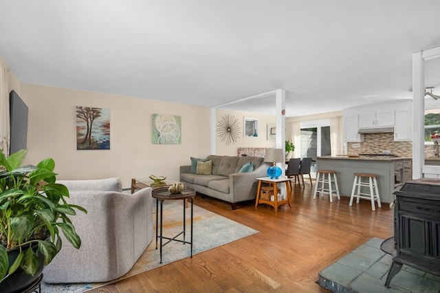 living room featuring light hardwood / wood-style flooring and a wood stove