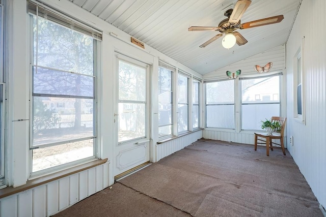 unfurnished sunroom with a healthy amount of sunlight, a ceiling fan, and lofted ceiling