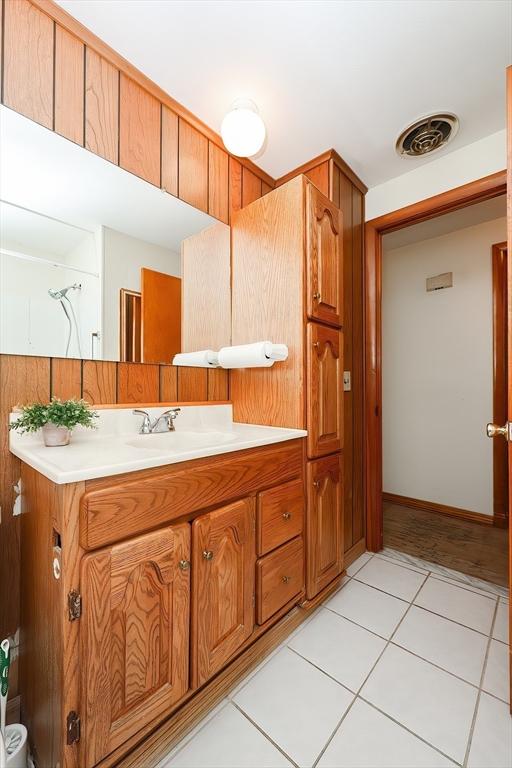 bathroom featuring tile patterned flooring, vanity, and visible vents