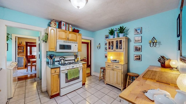 235-237 Corey Rd, Boston, MA 02135 - kitchen featuring white appliances, light tile patterned floors, light brown cabinets, glass insert cabinets, and butcher block counters
