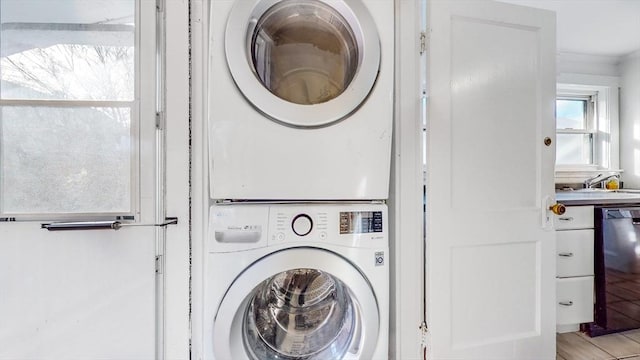 235-237 Corey Rd, Boston, MA 02135 - laundry area featuring stacked washing machine and dryer and ornamental molding