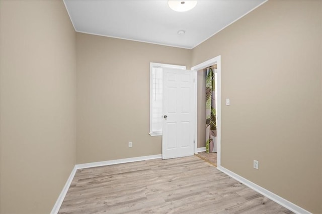 empty room featuring light wood-style floors and baseboards