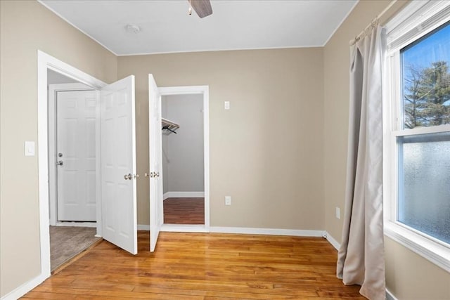 unfurnished room with light wood-style flooring and baseboards